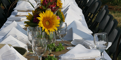 Table with sunflower centerpieces at Jones Valley Teaching Farm set for an outdoor dinner 