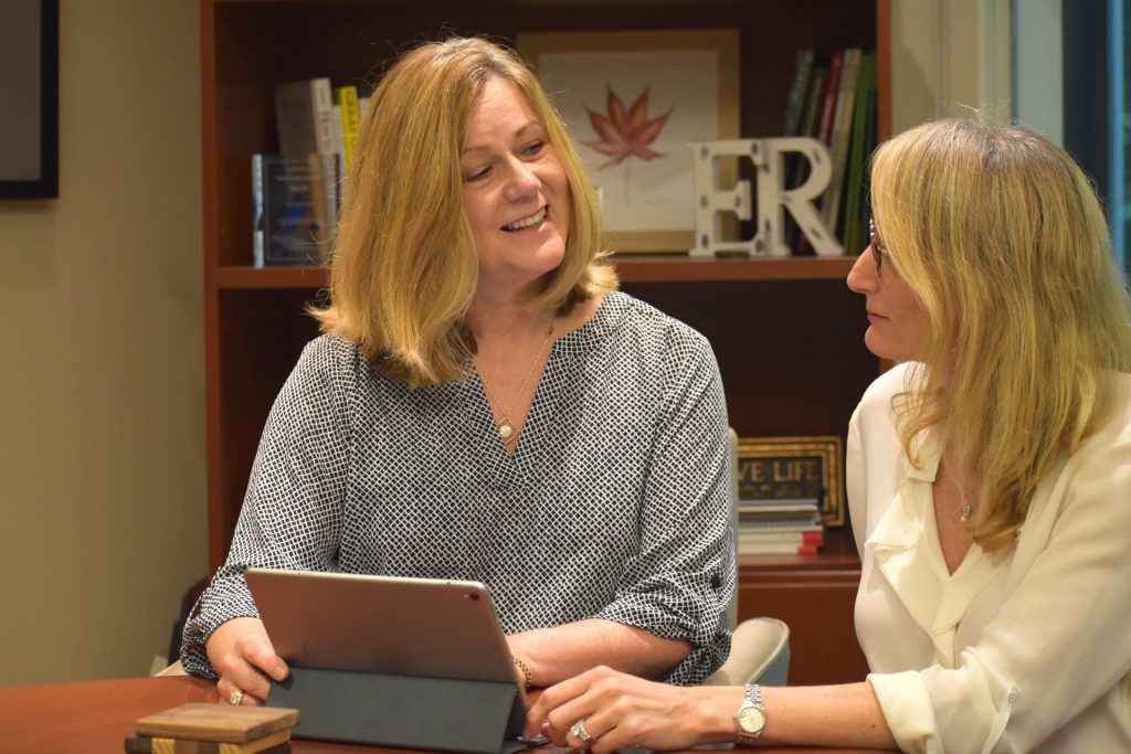 Two women discussing philanthropy.