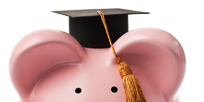 A pink piggy bank with a graduation cap on top. 