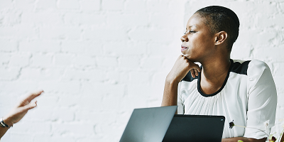 Professional woman listening to colleague talk