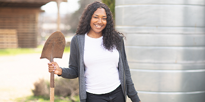 Jones Valley Teaching Farm instructor Shundria Mack standing with a shovel