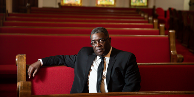 Reverend Arthur Price, Jr. pastor of the historic Sixteenth Street Baptist Church in Birmingham, Alabama, sits in a church pew