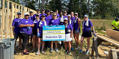 Protective employees standing outside at construction site for Habitat for Humanity home build