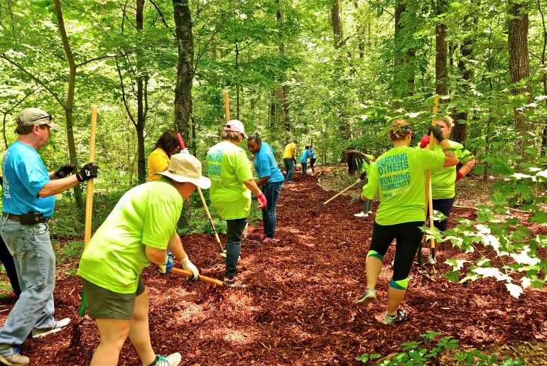 Protective Life volunteers working outside on a beautiful day.