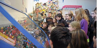 A group of children gathers around an exhibit at the Southern Environmental center.