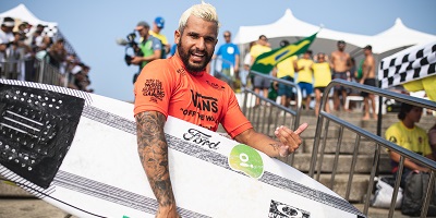Italo Ferreira posing with surfboard