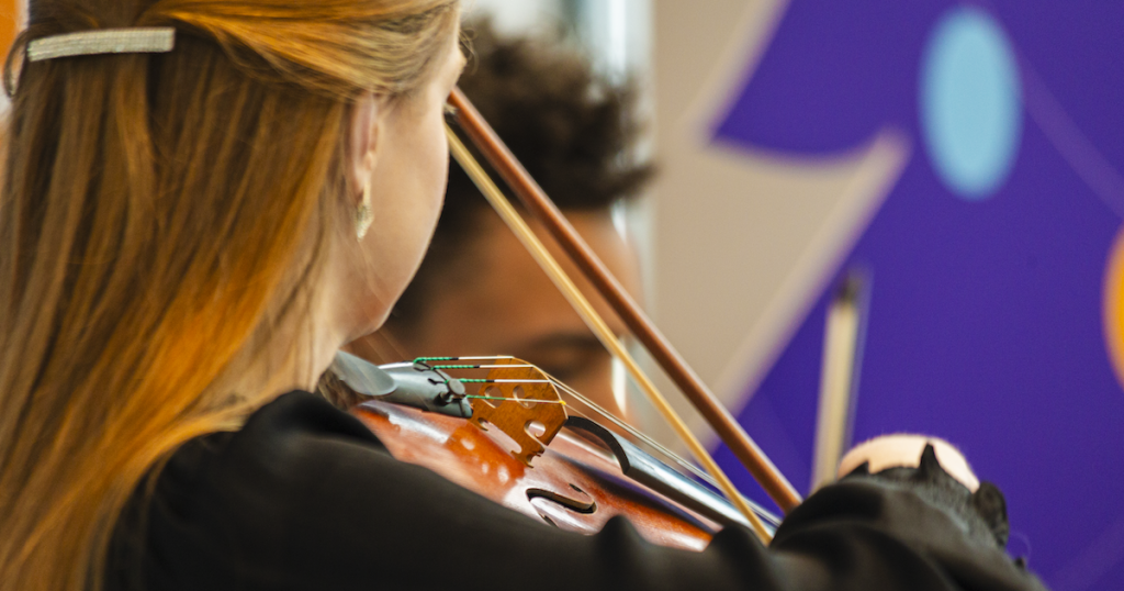 Musician playing violin at Protective Holiday Market