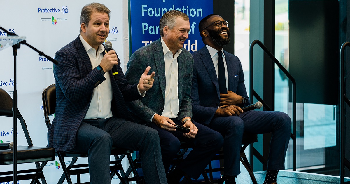 Nick Sellers, Scott Adams and Randall Woodfin smiling on stage
